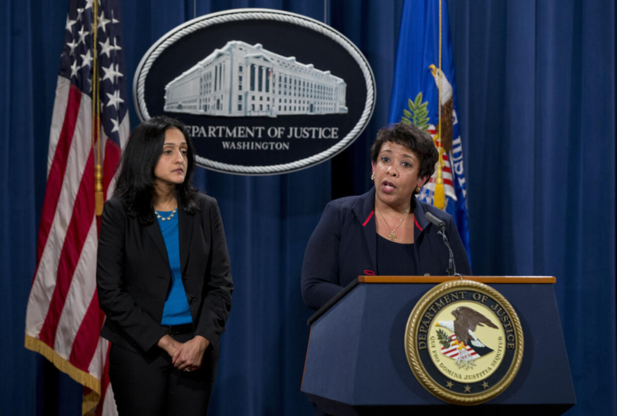 FILE - Attorney General Loretta Lynch, joined by Principal Deputy Assistant Attorney General Vanita Gupta speaks during a news conference at the Justice Department in Washington, Wednesday, Feb. 10, 2016, about Ferguson, Mo. The federal government sued Ferguson on Wednesday, one day after the city council voted to revise an agreement aimed at improving the way police and courts treat poor people and minorities in the St. Louis suburb.