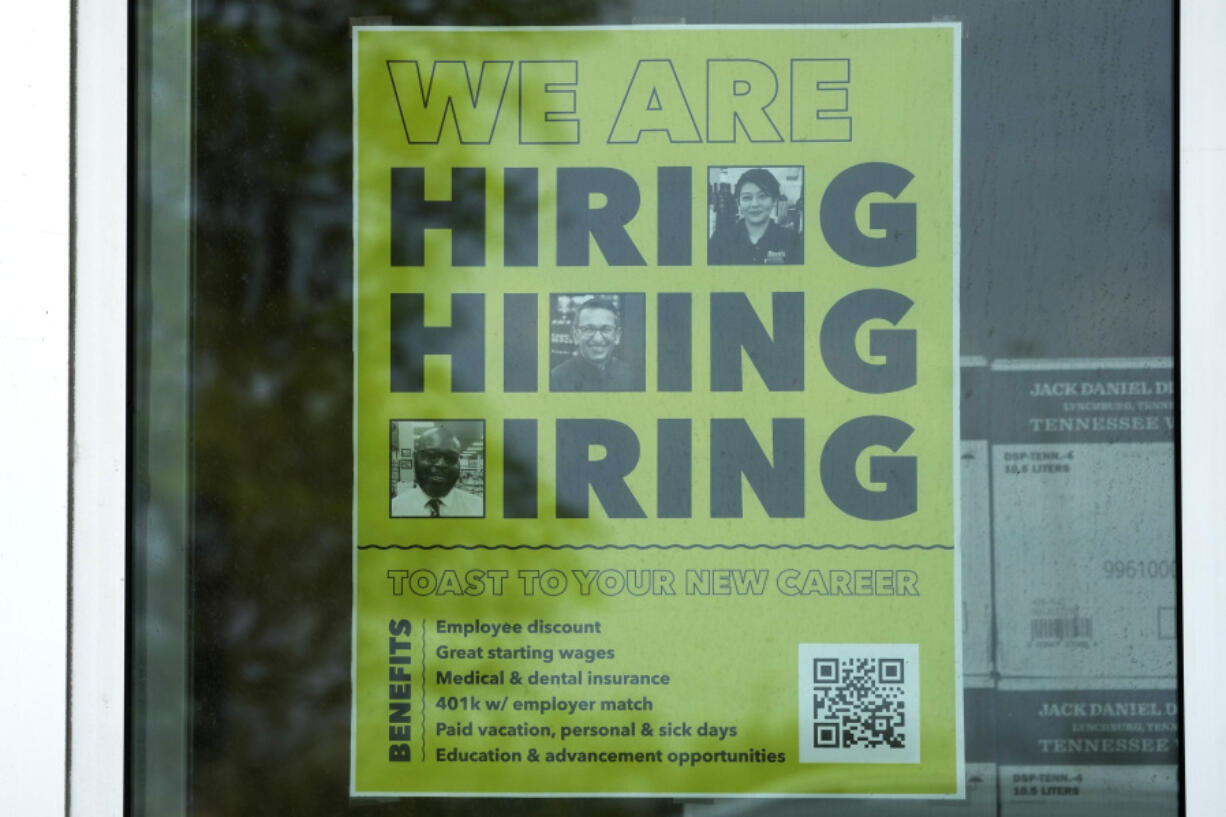 FILE - A hiring sign is displayed at a liquor store in Arlington Heights, Ill., May 21, 2024. (AP Photo/Nam Y.