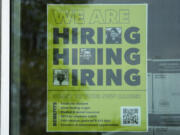 FILE - A hiring sign is displayed at a liquor store in Arlington Heights, Ill., May 21, 2024. (AP Photo/Nam Y.