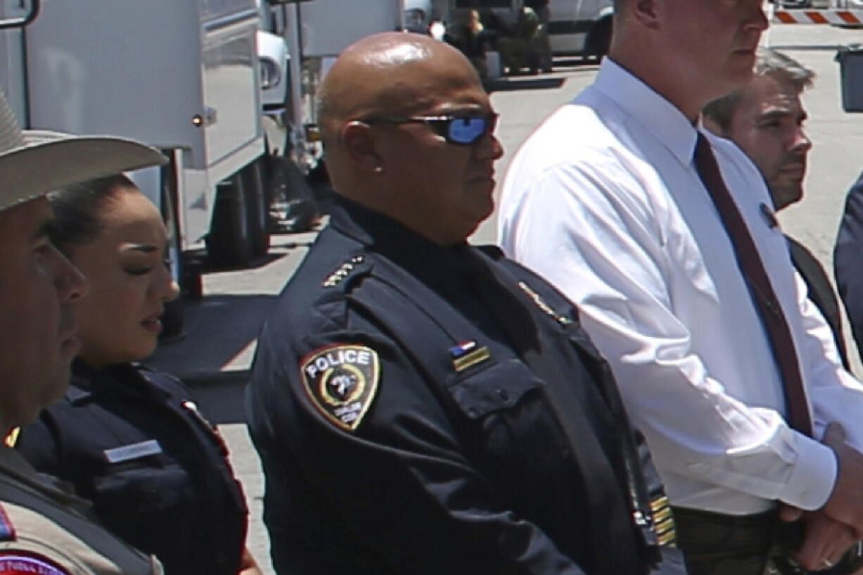 FILE - Uvalde School Police Chief Pete Arredondo, third from left, stands during a news conference outside of the Robb Elementary school on May 26, 2022, in Uvalde, Texas.