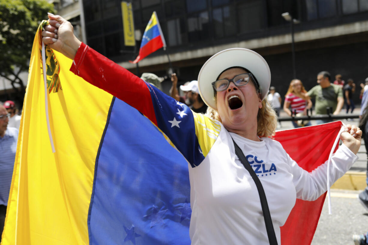 Opposition supporters protest the reelection of President Nicol&aacute;s Maduro one month after the disputed vote, which opposition leaders claim they won by a landslide, in Caracas, Venezuela, Wednesday, Aug. 28, 2024.