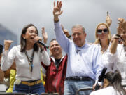 Opposition leader Maria Corina Machado, left, and opposition presidential candidate Edmundo Gonzalez address supporters from the top of a truck during a protest against the official presidential election results declaring President Nicolas Maduro the winner in Caracas, Venezuela, on Tuesday, July 30, 2024, two days after the vote.