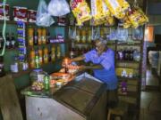 A man lights a candle in his shop during a blackout in Caracas, Venezuela, on Friday.