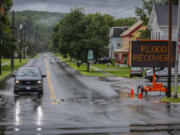 Water floods a roadway amid storms in Lyndon, Vt., Wednesday, July 31, 2024.