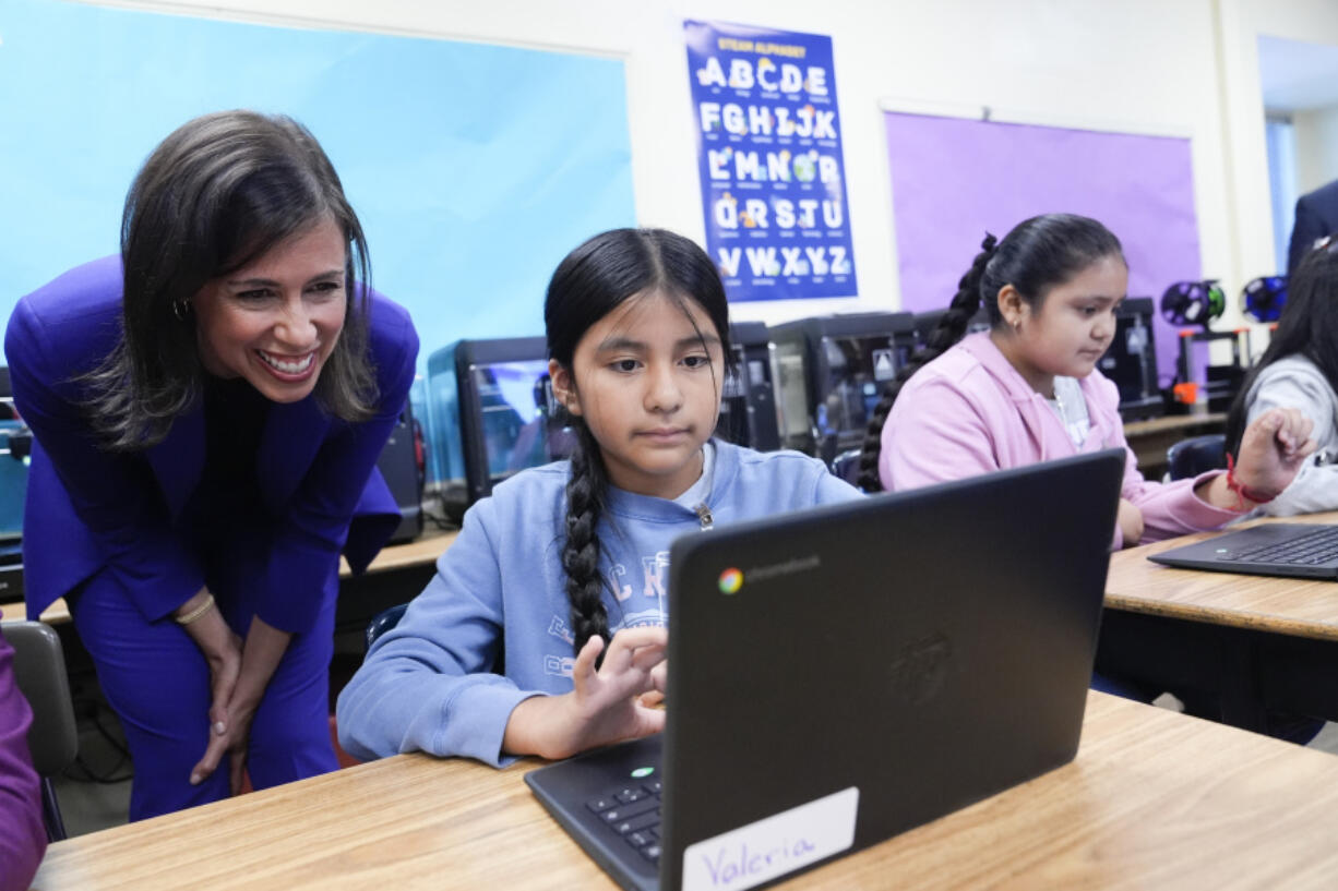 Jessica Rosenworcel, Chairwoman of the Federal Communications Commission, talks to a student in a STEM lab during a visit to Union Avenue Elementary, Tuesday, Aug. 13, 2024, in Los Angeles.