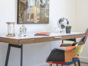 Artwork and creative accents including a patchwork inspired desk chair, helps to make this office feel festive.