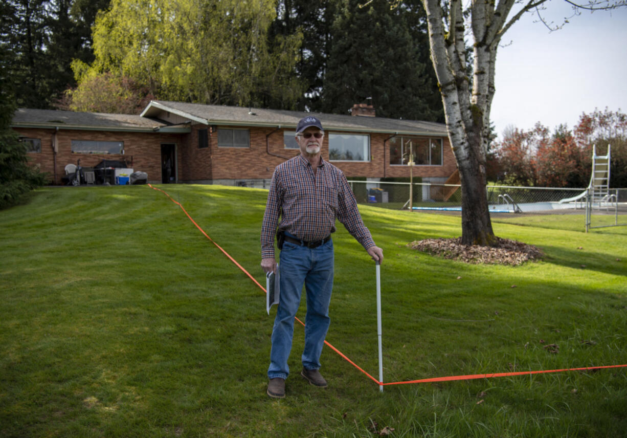 Dean Hergesheimer, outside his Fairgrounds neighborhood home in April 2022, and his neighbors have been battling the county&rsquo;s decision not to improve their road despite new homes added to the area.