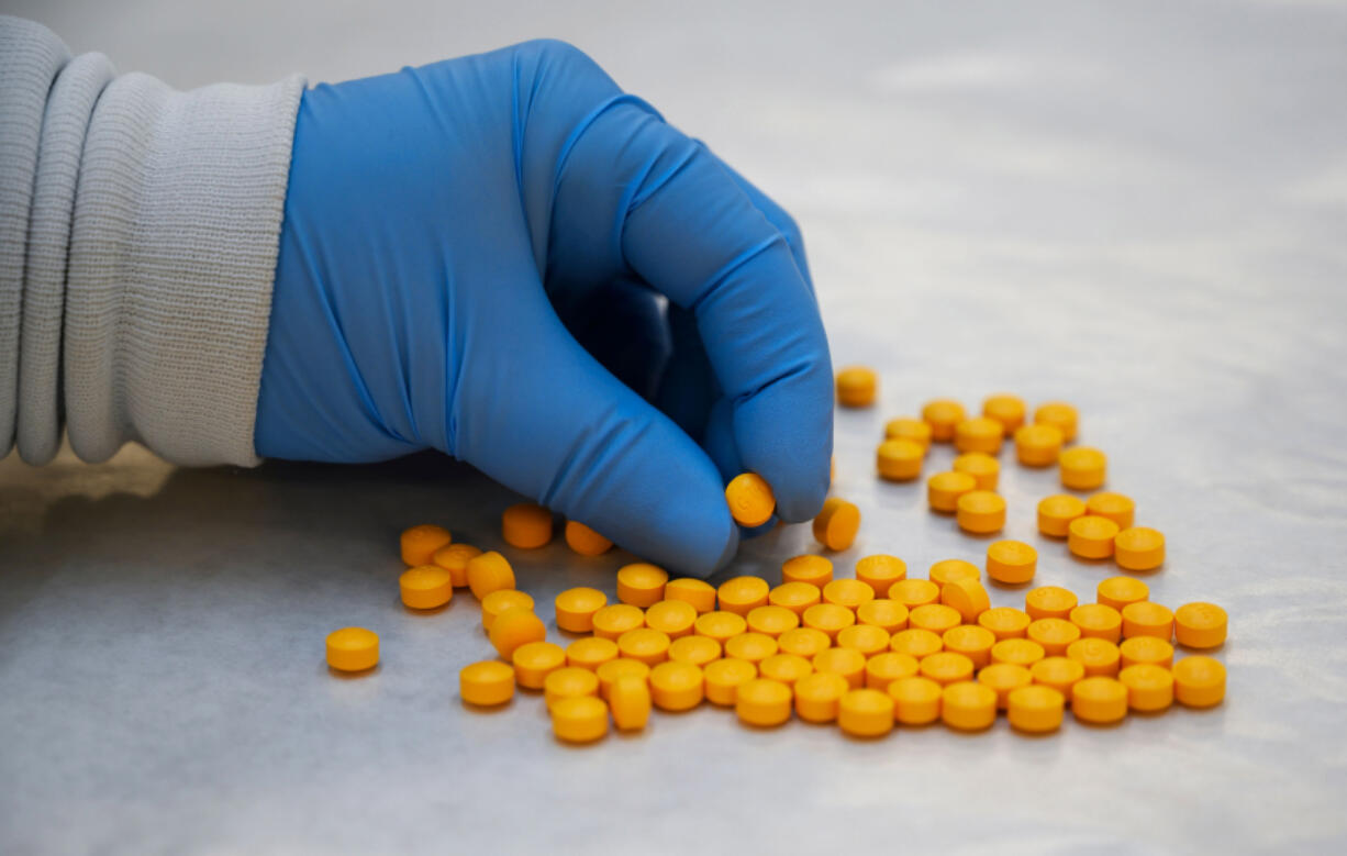 A Drug Enforcement Administration chemist checks confiscated tablets containing fentanyl at the DEA Northeast Regional Laboratory on Oct. 8, 2019, in New York.