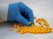 A Drug Enforcement Administration chemist checks confiscated tablets containing fentanyl at the DEA Northeast Regional Laboratory on Oct. 8, 2019, in New York.