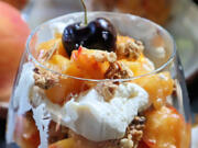 Individual peach parfaits layered with homemade granola and with spiced whipped cream are a crowd-pleasing dessert.