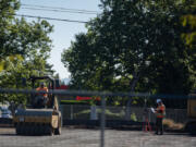 Construction workers make way for new businesses near New Seasons Market in Fisher&rsquo;s Landing. The construction industry in Clark County has lost nearly 1,000 jobs since last summer.