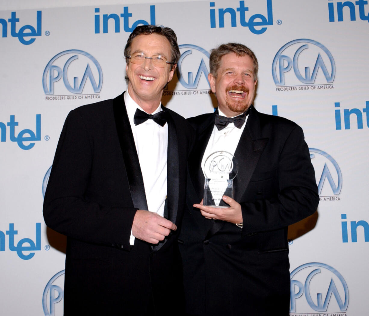 Producer John Wells, right, and writer Michael Crichton pose in the press room Jan. 22, 2005, at the 16th Annual Producers Guild Awards at Culver Studios in Culver City, Calif.