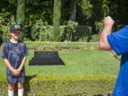 Henry Fallon, 10, left, has his photo take Aug. 5 by his father TJ near the gravesite of President Richard Nixon at The Richard Nixon Library &amp; Museum in Yorba Linda, Calif.