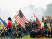 A child reenactor carries a flag during the 160th reenactment of the Battle of Gettysburg, at Daniel Lady Farm in Gettysburg, Pennsylvania, on June 30, 2023. The production of Kathryn Bigelow&Ccedil;&fnof;&Uacute;s upcoming Netflix feature wanted to use the reenactment as background.