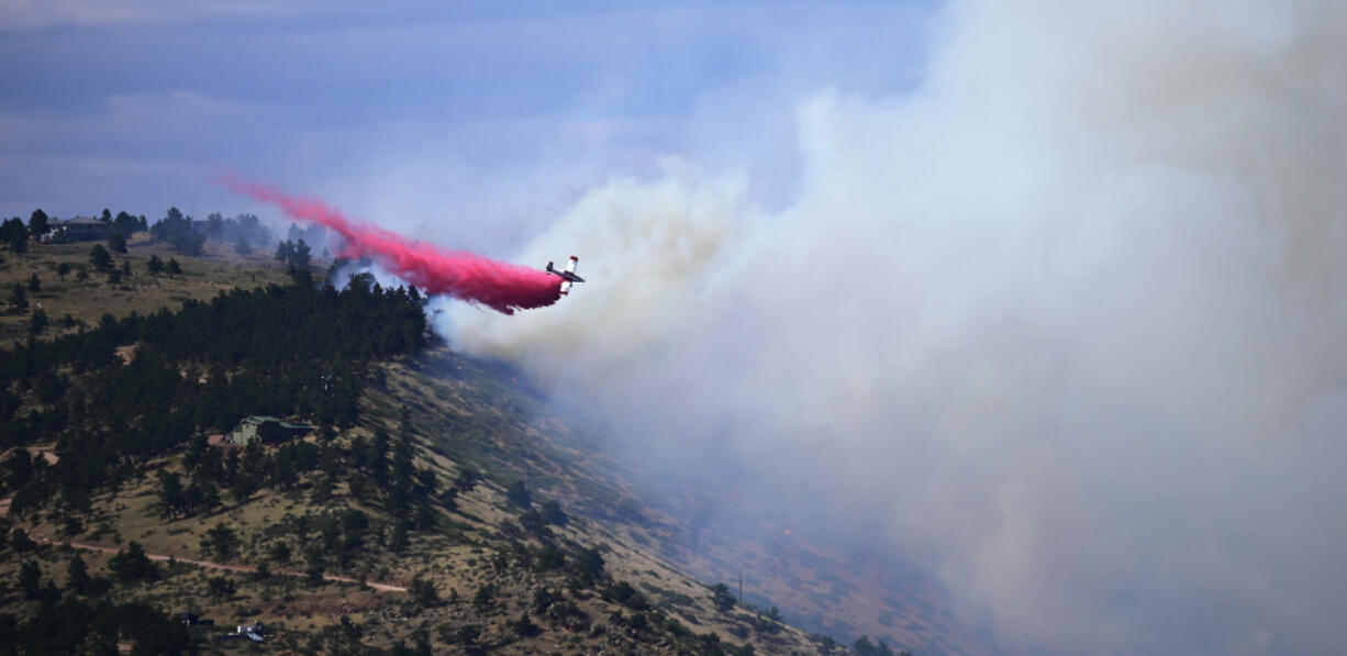 A single engine air tanker drops retardant on the Stone Canyon fire near Lyons on Tuesday, July 30, 2024.