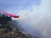 A single engine air tanker drops retardant on the Stone Canyon fire near Lyons on Tuesday, July 30, 2024.