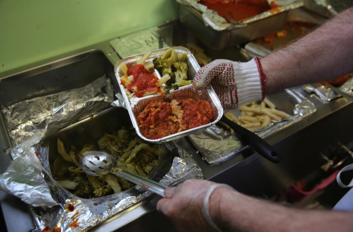 A Catholic Services worker prepares &ldquo;meals on wheels&rdquo; lunch delivery on March 12, 2014, in Franklin, New Jersey.