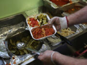 A Catholic Services worker prepares &ldquo;meals on wheels&rdquo; lunch delivery on March 12, 2014, in Franklin, New Jersey.