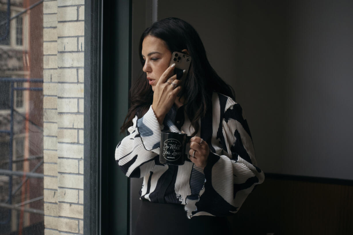 Entrepreneur Becky Litvintchouk makes a call Aug. 12 at a co-working space in New York. An app called Claude helps her manage her business.