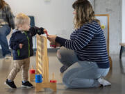 Avery Nearents, 18 months old of Vancouver, left, gets some one-on-one playtime with his mom, Hailey, at a 2023 Columbia Play Project session at Fourth Plain Commons Community Center.