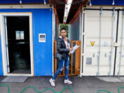 Case manager Johnnaya Banks walks between a larger community space, left, and the kitchen, at the Henderson Village tiny houses in Rainier Beach, Monday, July 29, 2024. Banks&Ccedil;&fnof;&Ugrave; salary is partially paid for by federal Medicaid funding that has been recently paused.