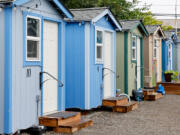 A row of brightly painted tiny houses at Henderson Village, Monday, July 29, 2024, in the Rainier Beach neighborhood of Seattle.