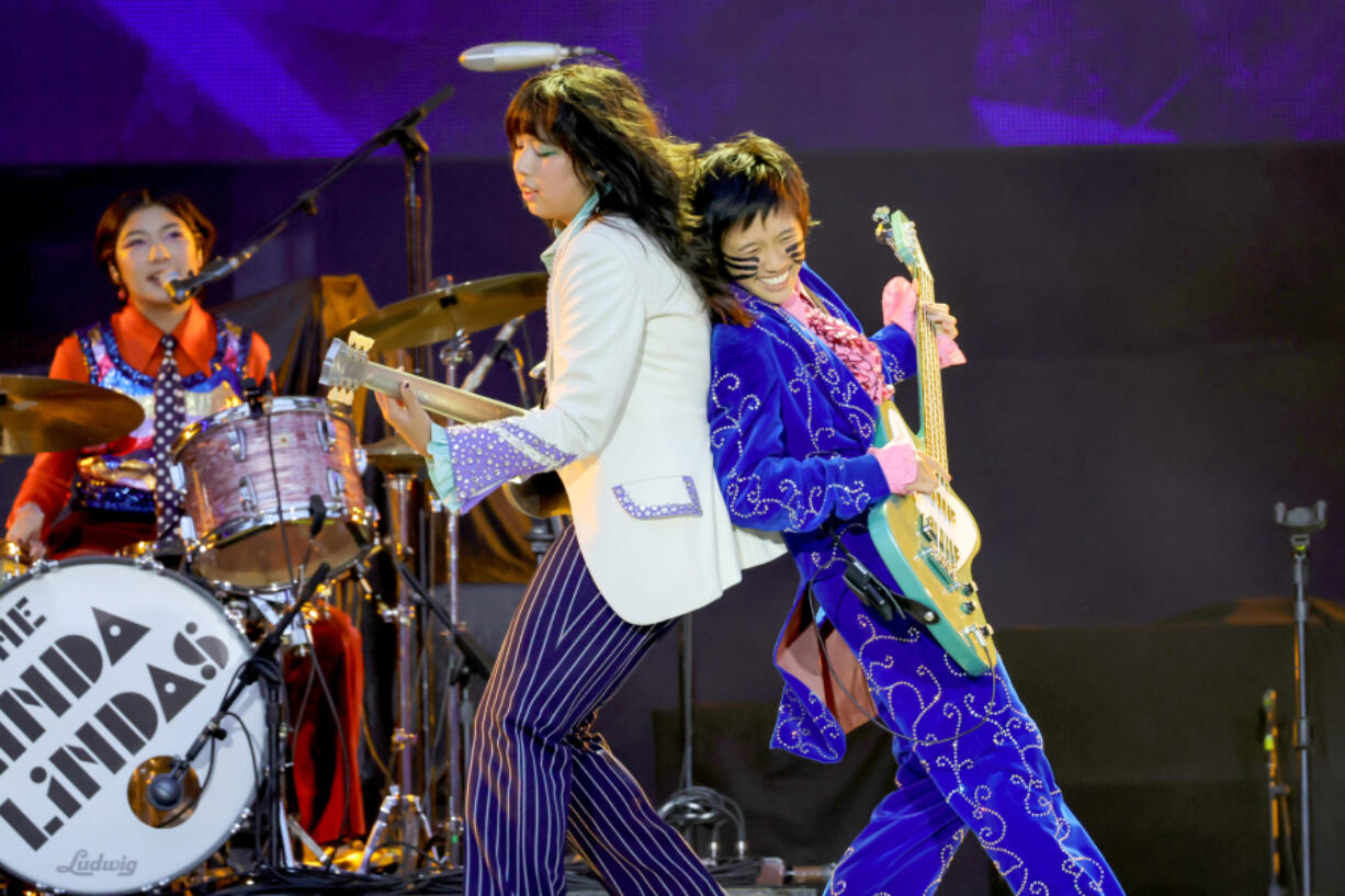 Mila de la Garza, from left, Lucia de la Garza and Eloise Wong of the Linda Lindas open for the Rolling Stones on July 13 at SoFi Stadium in Inglewood, Calif.