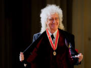 Queen guitarist Brian May poses March 14, 2023, with his medal after being appointed as a Knight Bachelor (Knighthood) during an investiture ceremony at Buckingham Palace in London.