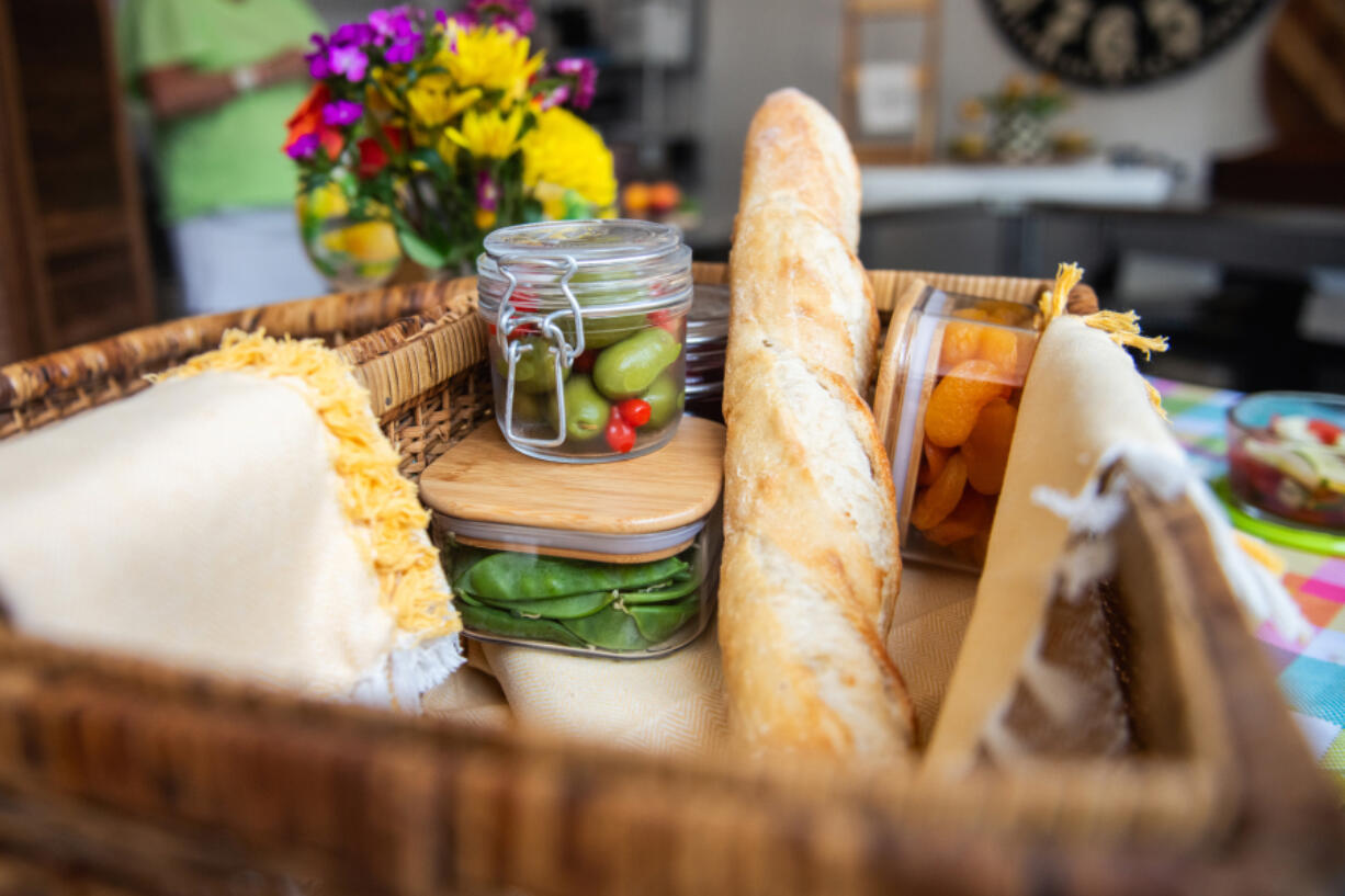 A the interior of a picnic basket is seen as it sits on display inside EZPZ Gatherings in Aspinwall on Monday, Aug. 5, 2024. The picnic basket was put together by owner Sarah Tuthill who recently published the cookbook &ldquo;Gathering Boards,&rdquo; which instructs people how to compose various picnic boards.