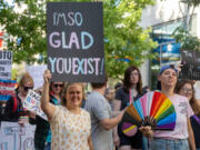 Demonstrators carry signs and flags in support of transgender people during the Trans March on Friday in Boise, Idaho.