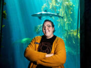 A leopard shark at the Monterey Bay Aquarium&rsquo;s Kelp Forest exhibit swims past Emily Simpson, the Aquarium&rsquo;s &ldquo;Content Strategist&rdquo; in Monterey, Calif., on Sept. 5.