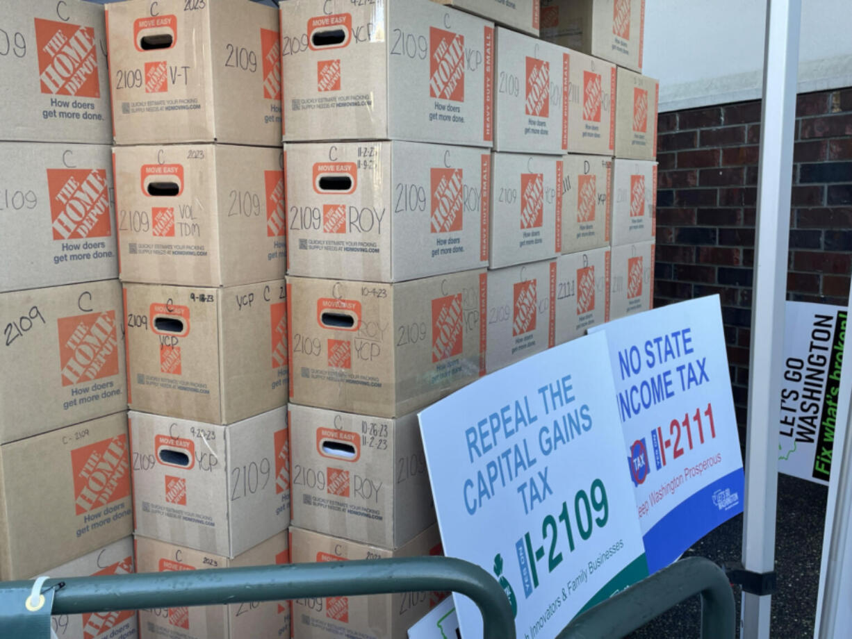 Let&rsquo;s Go Washington, a political committee, faces allegations it did not properly disclose information on money raised and spent in its signature-gathering drives for six initiatives in 2023. These boxes contain signed petitions for one of them, Initiative 2109, which would to repeal Washington state&rsquo;s capital gains tax. It will be on ballots in November 2024.