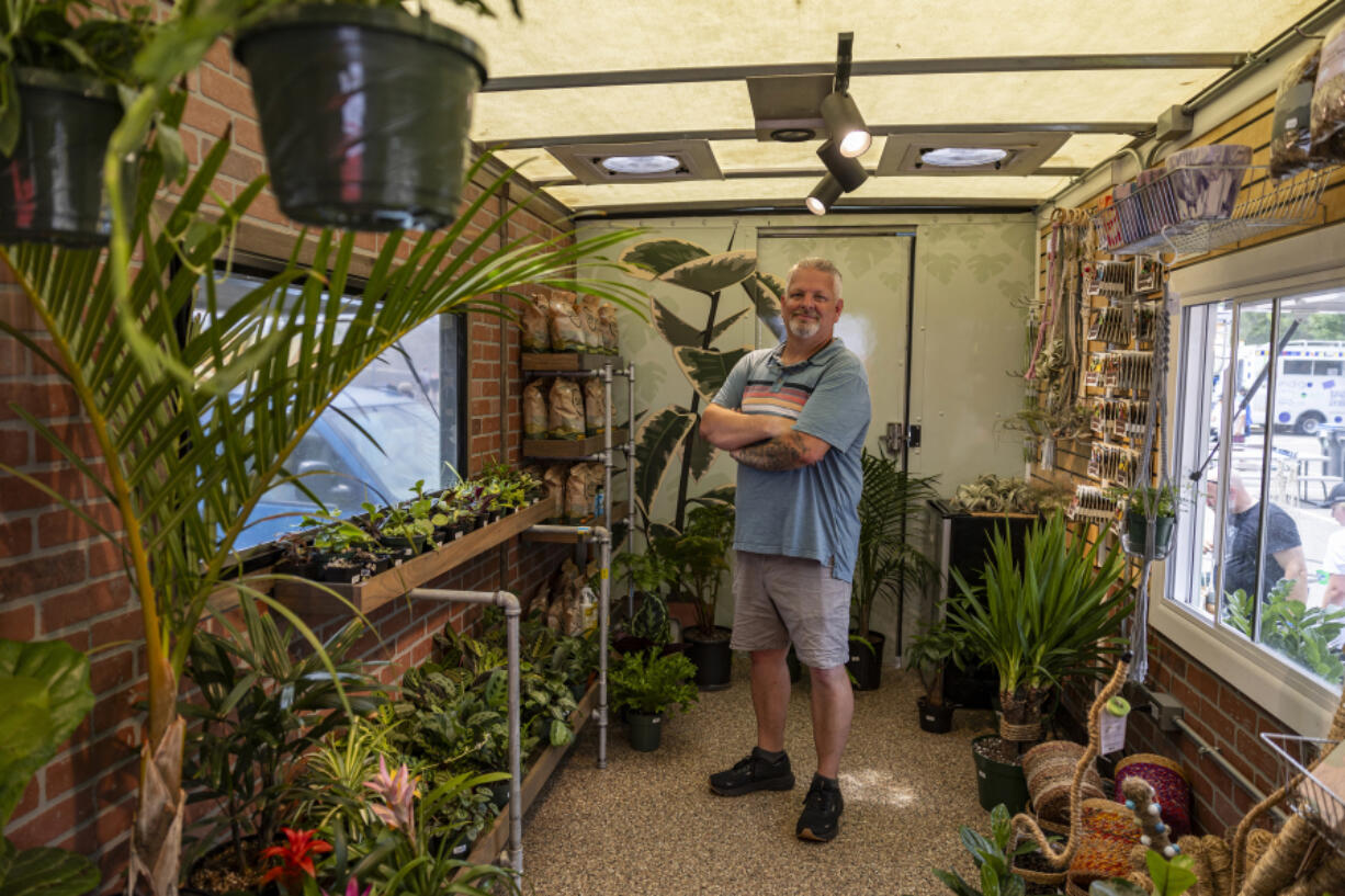 Roots, Shoots and Leaves owner Marc Eaton stands July 14 in the back of his truck during the St. Paul Food Truck Festival at Union Depot Lot C in St. Paul, Minn.