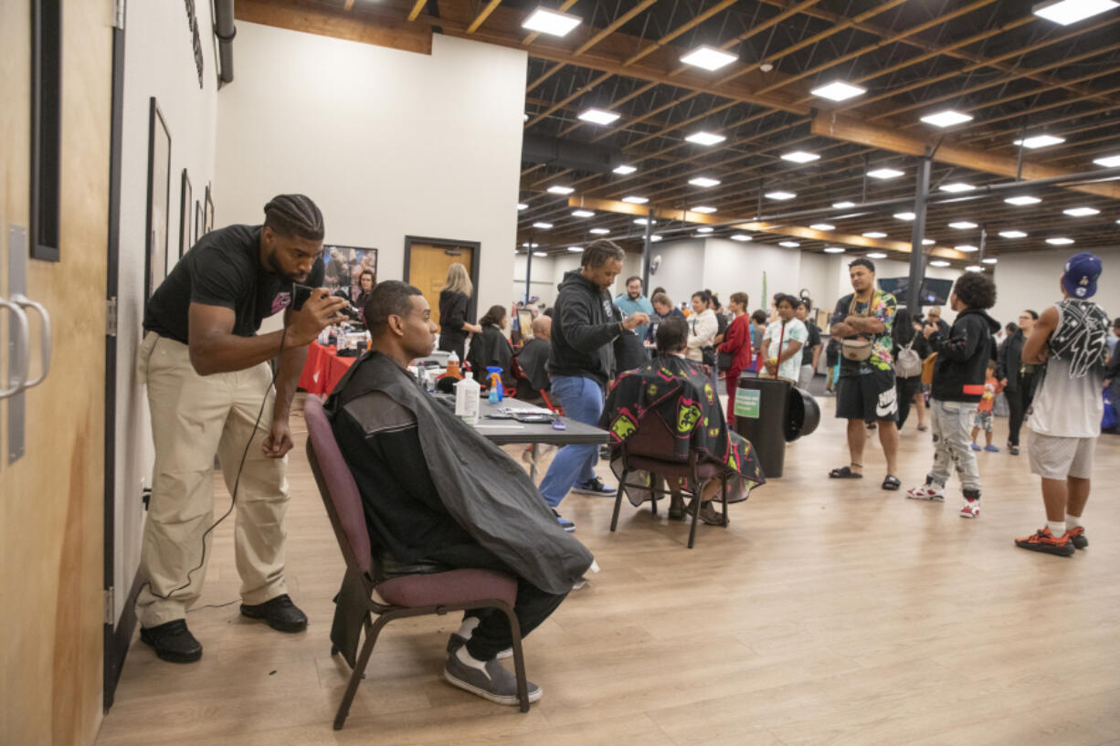 Rashan Williams of Shifted Theory, left, cuts Tarence Kibby&rsquo;s hair at a Thrive2Survive event at Living Hope Church on Saturday.