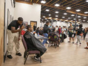 Rashan Williams of Shifted Theory, left, cuts Tarence Kibby&rsquo;s hair at a Thrive2Survive event at Living Hope Church on Saturday.