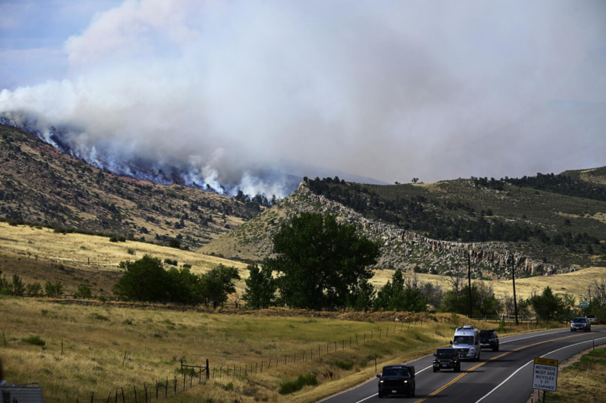 Smoke rises July 30 from a wildfire in the Rocky Mountain foothills near Lyons, Colo.