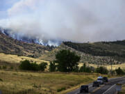 Smoke rises July 30 from a wildfire in the Rocky Mountain foothills near Lyons, Colo.