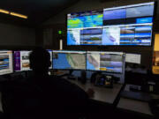 Scott Slumpff of the California Department of Forestry and Fire Protection monitors computer screens last year that depict provide views of wildfire camera systems throughout the state at the Southern California Geographic Area Coordination Center in Moreno Valley, Calif.