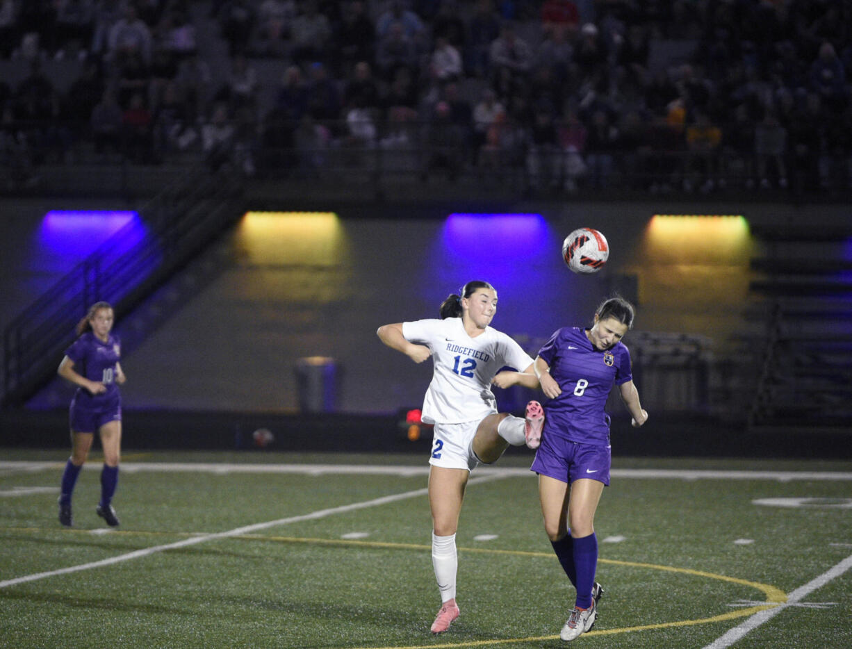 Columbia River's Maya Delgadillo (8) heads the ball as Ridgefield's Marlee Buffham (12) defends during a 2A Greater St. Helens League girls soccer game on Thursday, Sept. 26, 2024, at Columbia River High School.