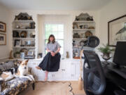 Stylist Katie Howie in her home office with her dog, Chip, on June 5. Howie shows how she layers vintage, new and family heirlooms.