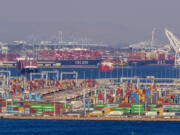 Dozoens of container ships sit off the coast of the Ports of Los Angeles and Long Beach, waiting to be unloaded, Oct. 13, 2021. Port officials say they&Ccedil;&fnof;&Ugrave;re better equipped to handle a surge of cargo if dock workers strike in the East Coast. (Allen J.