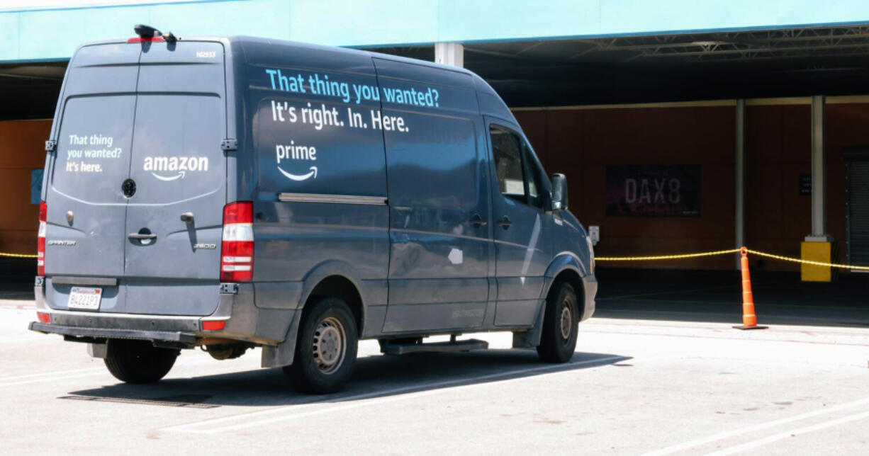 A delivery vehicle that has been grounded from a crack in its rear light is seen near a sign that notes the distribution location, DAX8, at Johnathon Ervin&rsquo;s distribution site for Amazon products on Friday, May 5, 2023 in Palmdale, CA. Ervin has decided to voluntarily unionize the company and wonders if Amazon is retaliating against his company.