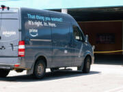 A delivery vehicle that has been grounded from a crack in its rear light is seen near a sign that notes the distribution location, DAX8, at Johnathon Ervin&rsquo;s distribution site for Amazon products on Friday, May 5, 2023 in Palmdale, CA. Ervin has decided to voluntarily unionize the company and wonders if Amazon is retaliating against his company.