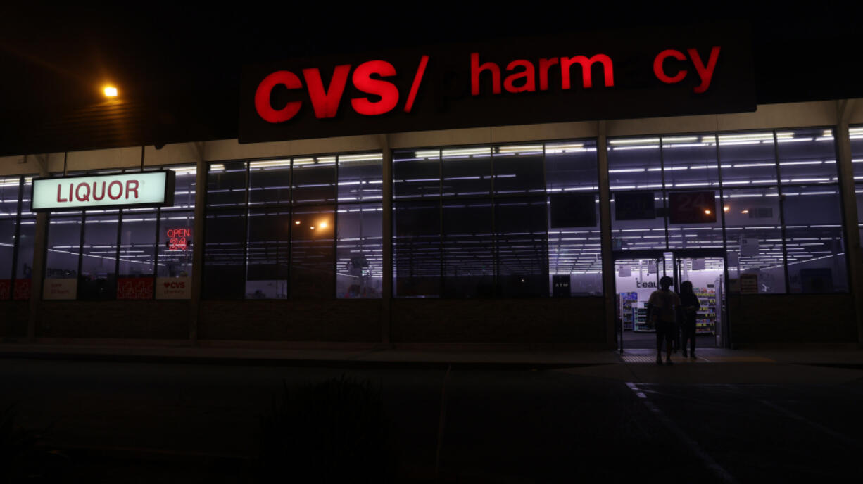 People walk into a CVS Pharmacy on Friday, Aug. 30, 2024, in Inglewood, California. Workers at the CVS specialty pharmacy in Redlands have filed a petition with the National Labor Relations Board seeking to hold a union election.