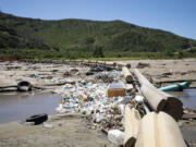 Sewage water filled with trash flows down the Tijuana River on  April 9, 2024, in Imperial Beach, California.