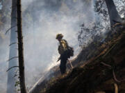 Cal Fire firefighter Eric Schnetz of Georgetown works to extinguish the Crozier fire in El Dorado County on Wednesday, Aug. 7, 2024.