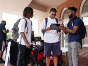 Marchellos Scott, right, helps Morehouse College students fill out a voter registration form at a college registration booth on Aug. 19, 2024, in Atlanta. Scott, 21, a student organizer at the college -- a private, historically Black university in Atlanta for men -- agreed that the mood &ldquo;really shifted&rdquo; with a younger Kamala Harris at the top of the Democratic ticket. &ldquo;We immediately stepped up and threw support behind her,&rdquo; Scott said. He has since been helping to drive student voter registration and plans to organize transport to polling stations on election day.