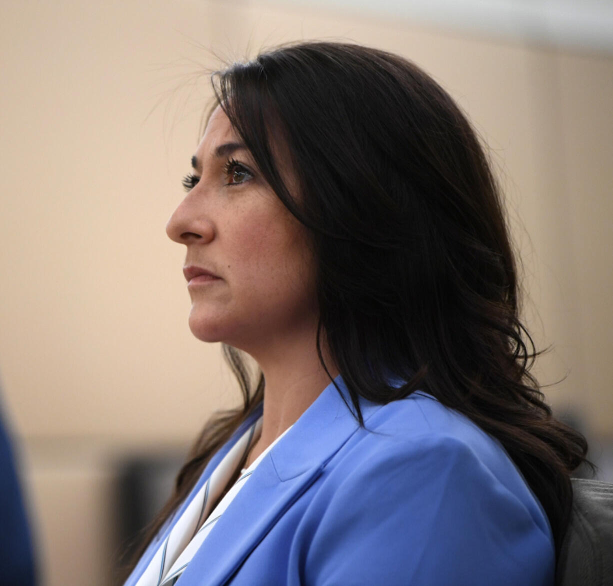 Vancouver Police Officer Andrea Mendoza watches her body cam footage April 22 at the Clark County Courthouse. Mendoza was charged with misdemeanor fourth-degree assault after threatening to use a Taser on the genitals of a suspected shoplifter in May 2023. A Clark County District Court jury acquitted her.