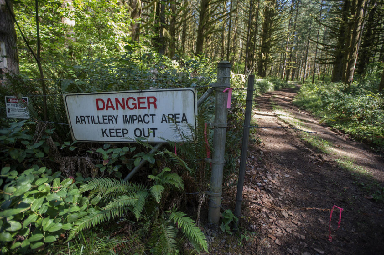 A sign and a barbed wire fence keeps visitors out of the artillery impact area at Camp Bonneville. A recently released audit by the state found the Department of Ecology has failed to perform required reviews of cleanup efforts at the county-owned property.