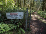 A sign and a barbed wire fence keeps visitors out of the artillery impact area at Camp Bonneville. A recently released audit by the state found the Department of Ecology has failed to perform required reviews of cleanup efforts at the county-owned property.